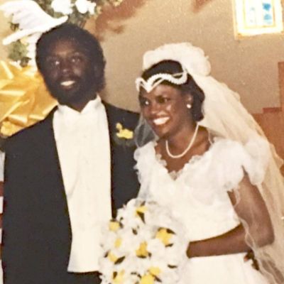 Both Val Demings and Jerry Demings are at their wedding while Val is holding flowers.